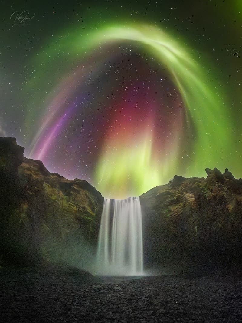 Colorful Aurora over Icelandic Waterfall